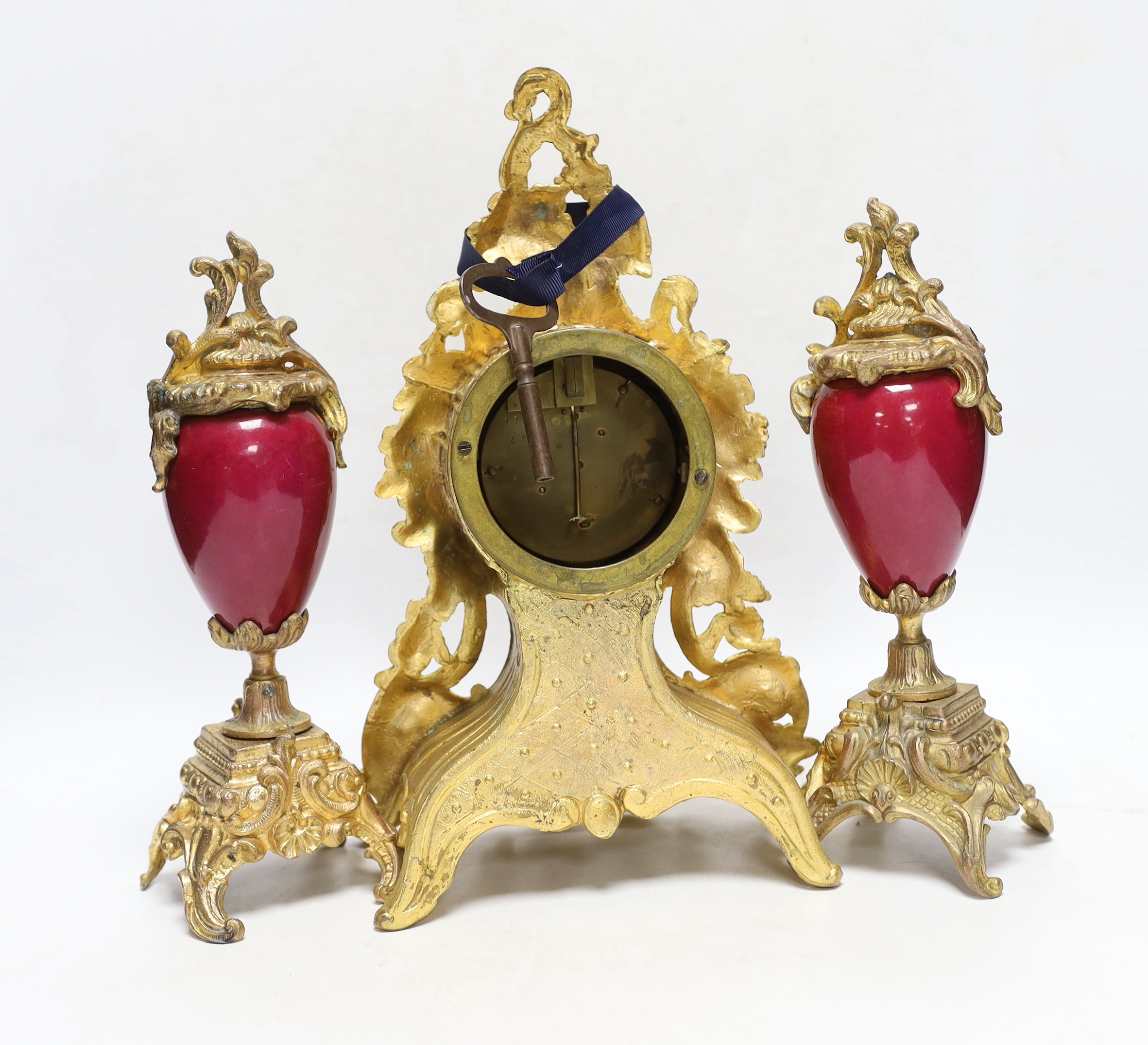 An early 20th century French gilt metal clock garniture, 30cm